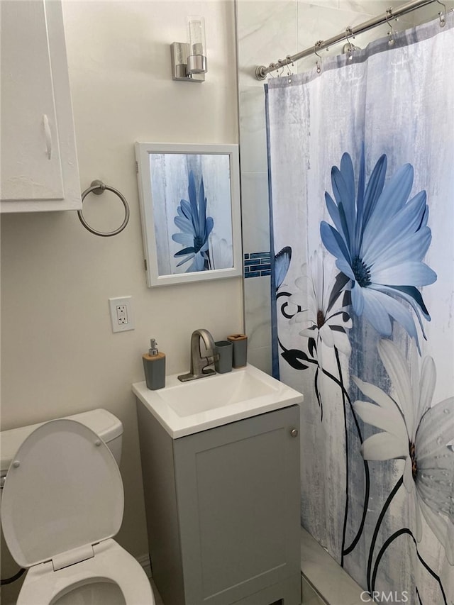 bathroom featuring vanity and toilet