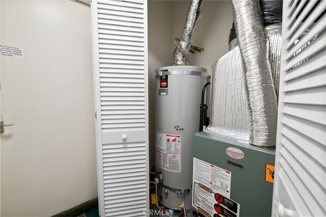 utility room featuring water heater