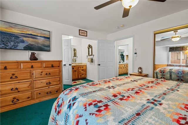 carpeted bedroom featuring ensuite bathroom, ceiling fan, and a closet