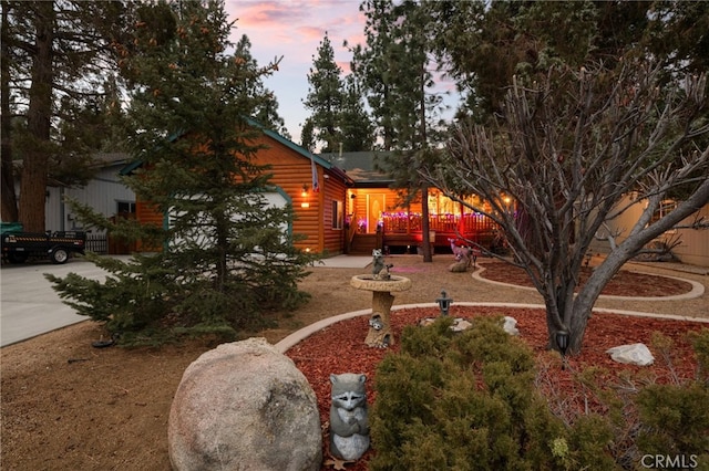 yard at dusk featuring a garage