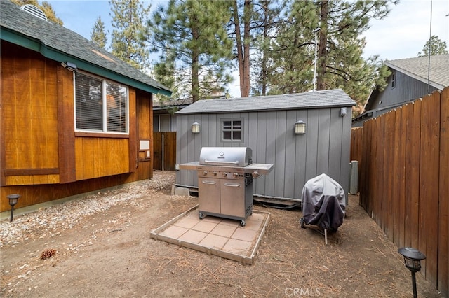 view of patio / terrace featuring area for grilling and a shed