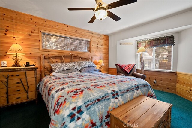 carpeted bedroom featuring wooden walls and ceiling fan