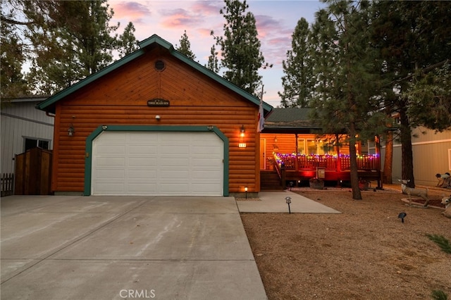 log-style house featuring a garage and an outdoor structure