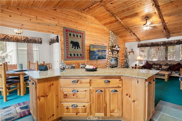 kitchen with carpet, ceiling fan, light stone counters, light brown cabinets, and wooden ceiling