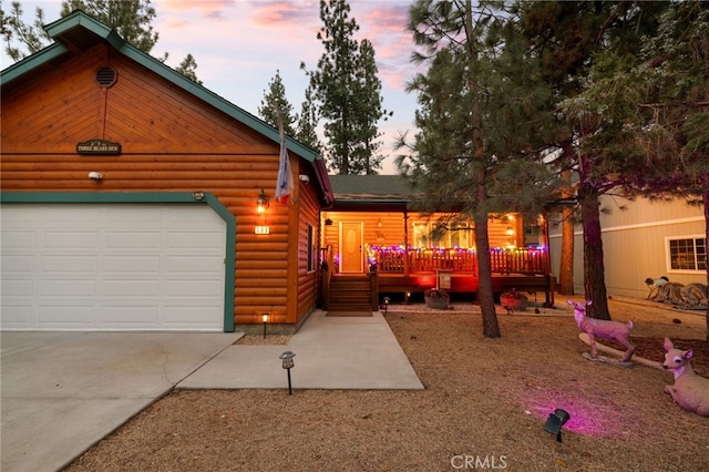 view of front of home featuring a garage and a wooden deck