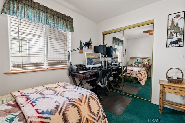 carpeted bedroom featuring multiple windows and a closet