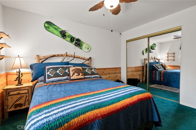 carpeted bedroom with wooden walls, a closet, and ceiling fan