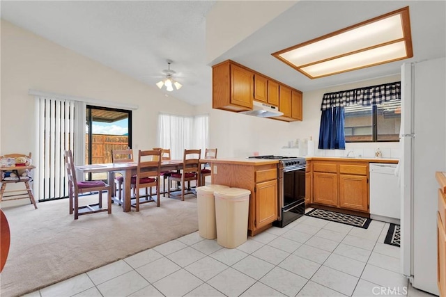 kitchen with white appliances, ceiling fan, vaulted ceiling, light colored carpet, and kitchen peninsula