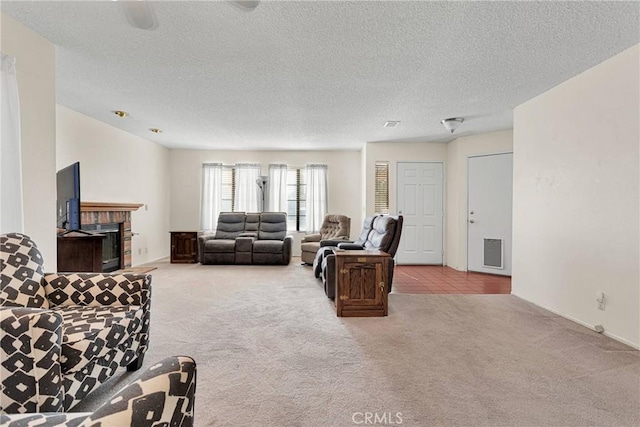 living room with light colored carpet, a brick fireplace, and a textured ceiling