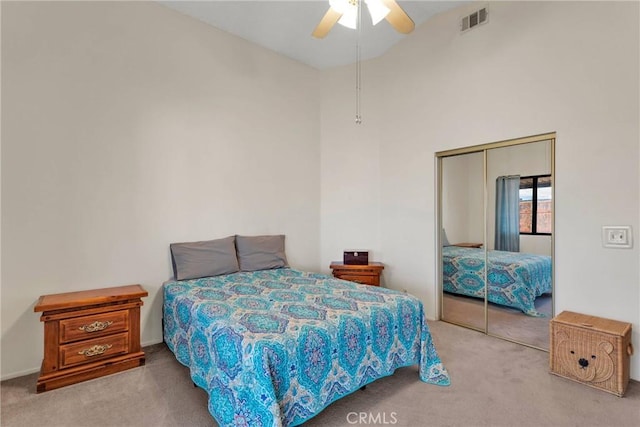 carpeted bedroom featuring a closet and ceiling fan