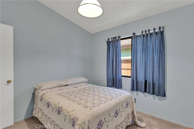 bedroom featuring lofted ceiling and light carpet