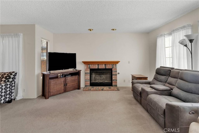 carpeted living room with a brick fireplace and a textured ceiling