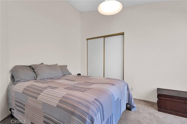 bedroom with light colored carpet and a closet