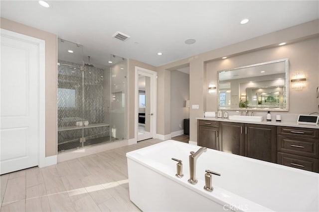 20436 W Liverpool Way, Porter Ranch, CA 91326 - bathroom with a shower stall, a freestanding bath, baseboards, vanity, and recessed lighting