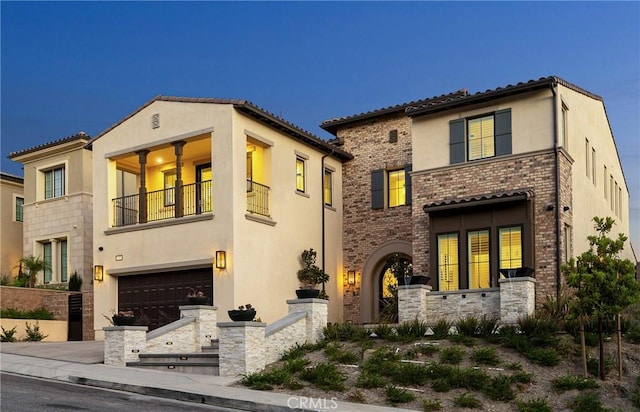20436 W Liverpool Way, Porter Ranch, CA 91326 - mediterranean / spanish home with a balcony, stucco siding, a garage, and driveway