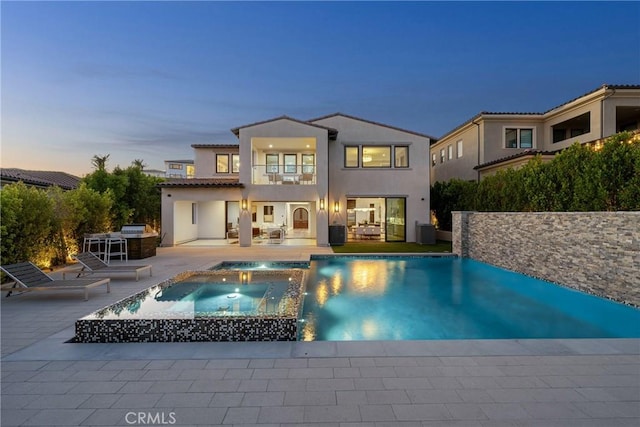 20436 W Liverpool Way, Porter Ranch, CA 91326 - rear view of property with a balcony, a patio, stucco siding, a pool with connected hot tub, and central air condition unit