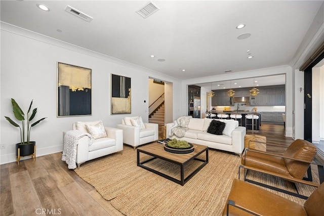 20436 W Liverpool Way, Porter Ranch, CA 91326 - living area featuring stairs, wood finished floors, crown molding, recessed lighting, and baseboards