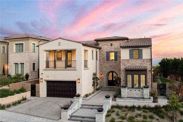 20436 W Liverpool Way, Porter Ranch, CA 91326 - mediterranean / spanish-style home with stucco siding, french doors, a balcony, driveway, and an attached garage