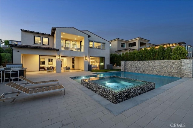 20436 W Liverpool Way, Porter Ranch, CA 91326 - rear view of property featuring a balcony, an in-ground hot tub, a patio area, an outdoor living space, and an outdoor pool