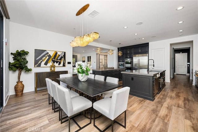 20436 W Liverpool Way, Porter Ranch, CA 91326 - dining area with light wood-type flooring and recessed lighting