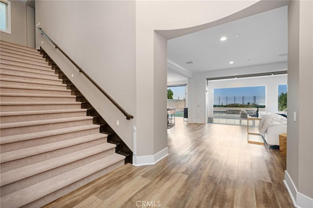 20436 W Liverpool Way, Porter Ranch, CA 91326 - stairs with wood finished floors, baseboards, healthy amount of natural light, and recessed lighting