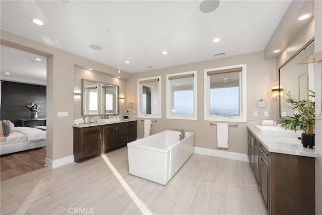 20436 W Liverpool Way, Porter Ranch, CA 91326 - full bath featuring a freestanding bath, baseboards, recessed lighting, and two vanities