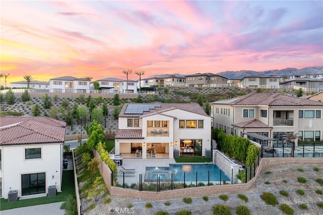 20436 W Liverpool Way, Porter Ranch, CA 91326 - back of property with a residential view, central AC unit, a balcony, and solar panels