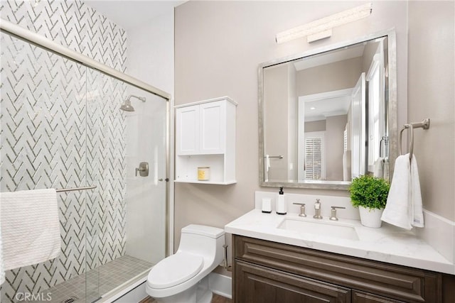 bathroom with vanity, toilet, and a shower with shower door