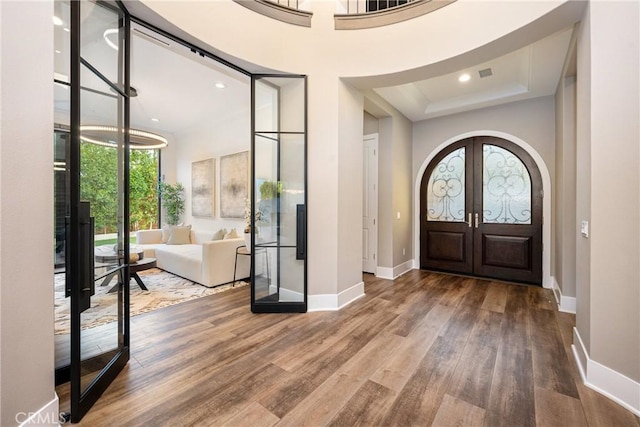 20436 W Liverpool Way, Porter Ranch, CA 91326 - entryway featuring french doors, baseboards, wood finished floors, arched walkways, and recessed lighting