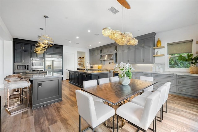 20436 W Liverpool Way, Porter Ranch, CA 91326 - dining room featuring a chandelier, recessed lighting, and wood finished floors