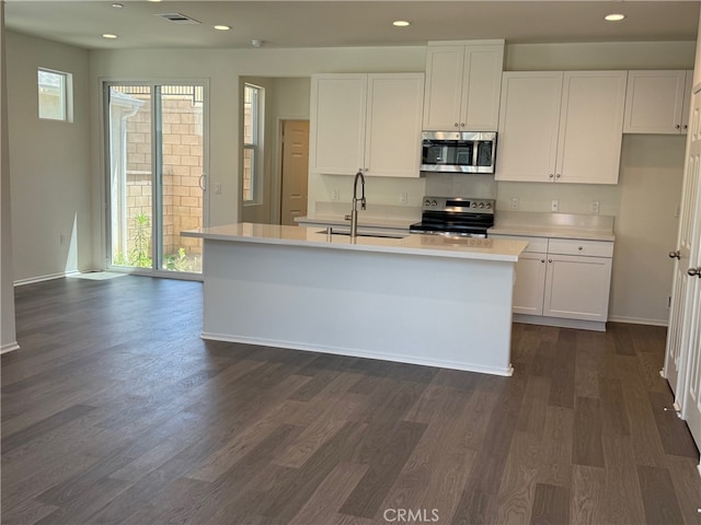 2255 Spring Meadow Ct, San Bernardino, CA 92346 - kitchen with appliances with stainless steel finishes, white cabinets, dark wood finished floors, light countertops, and recessed lighting