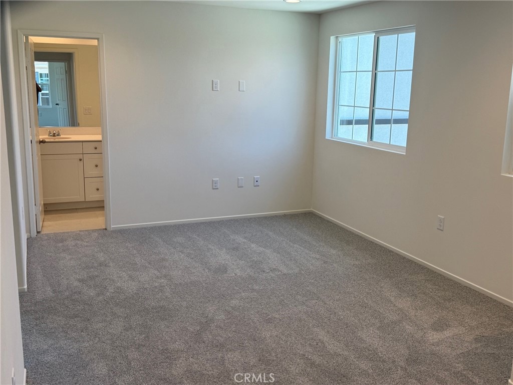 2255 Spring Meadow Ct, San Bernardino, CA 92346 - unfurnished bedroom with light colored carpet and connected bathroom