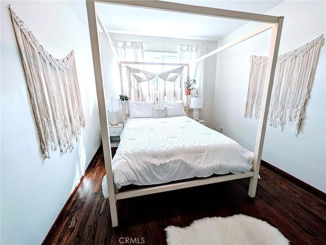 bedroom with dark wood-type flooring