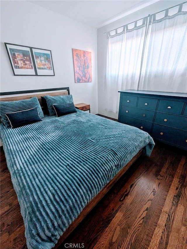 bedroom featuring dark hardwood / wood-style flooring