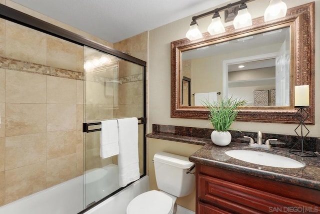 full bathroom with vanity, shower / bath combination with glass door, and toilet