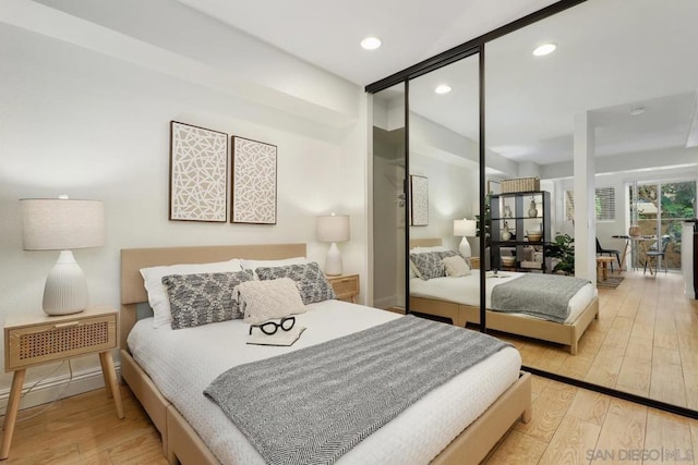 bedroom featuring light hardwood / wood-style floors and a closet