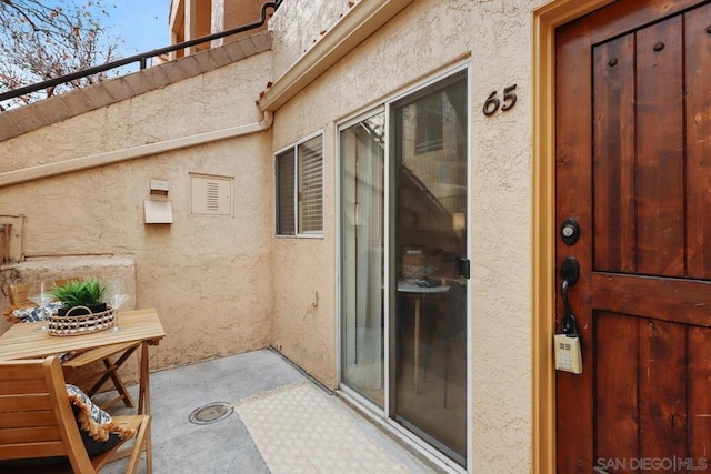 doorway to property with a patio area