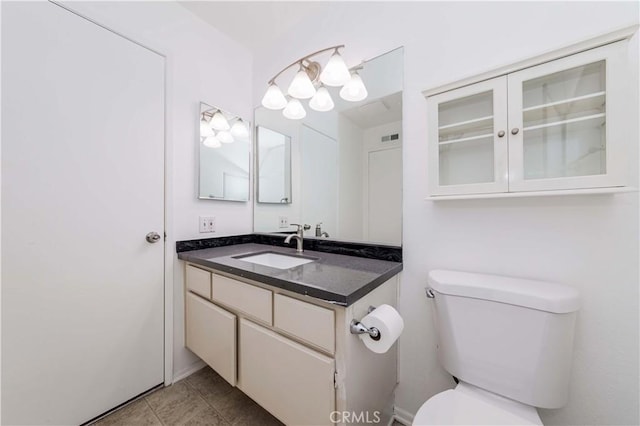 bathroom with vanity, toilet, and tile patterned flooring