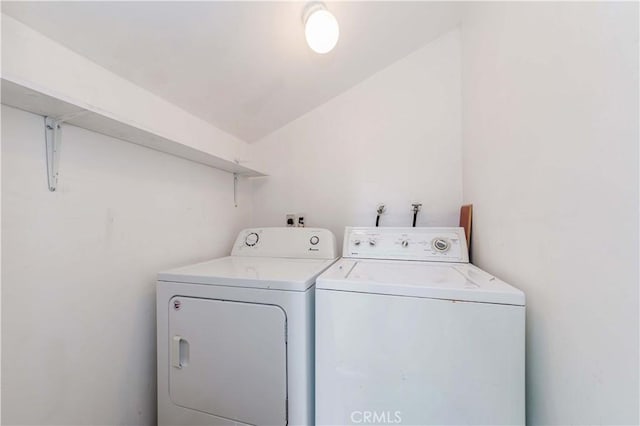 clothes washing area featuring washer and clothes dryer and laundry area