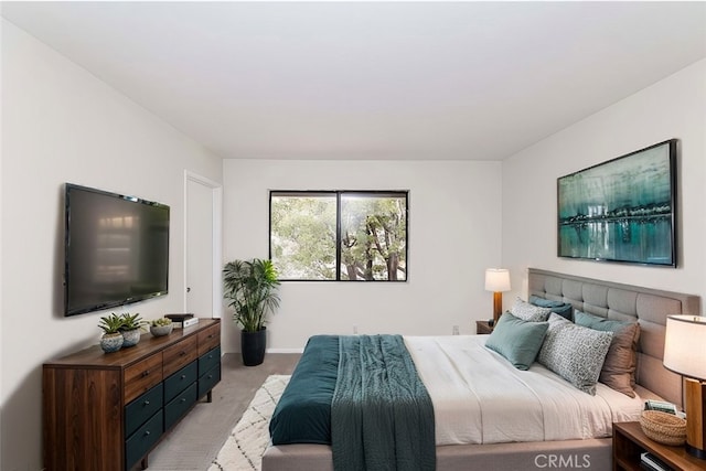 bedroom featuring light colored carpet