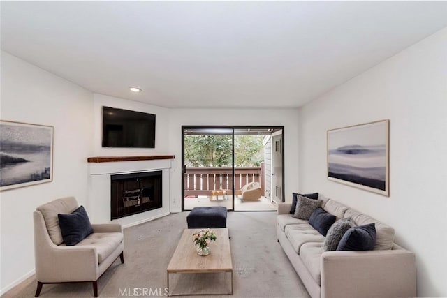 carpeted living room with recessed lighting, baseboards, and a fireplace