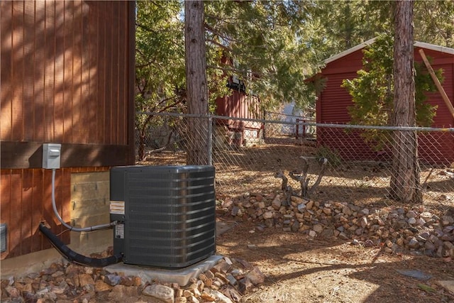 details featuring fence and central AC unit