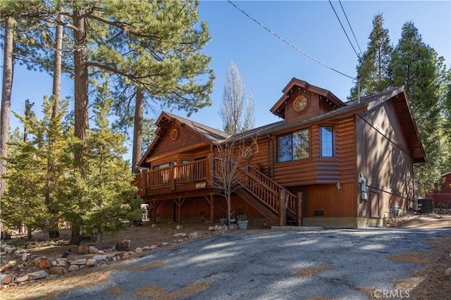 view of front of home featuring a deck, crawl space, central AC unit, and stairs