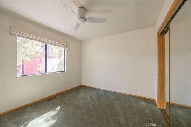 unfurnished bedroom with a ceiling fan, visible vents, baseboards, a closet, and carpet