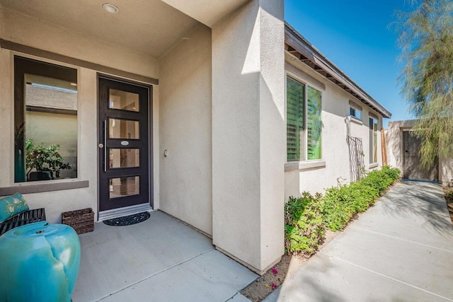 view of exterior entry featuring a patio