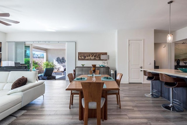 dining area featuring ceiling fan and dark hardwood / wood-style flooring