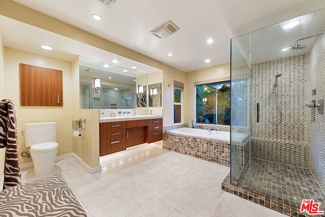 full bathroom featuring independent shower and bath, vanity, tile patterned floors, and toilet