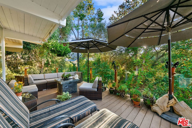 wooden terrace with an outdoor living space