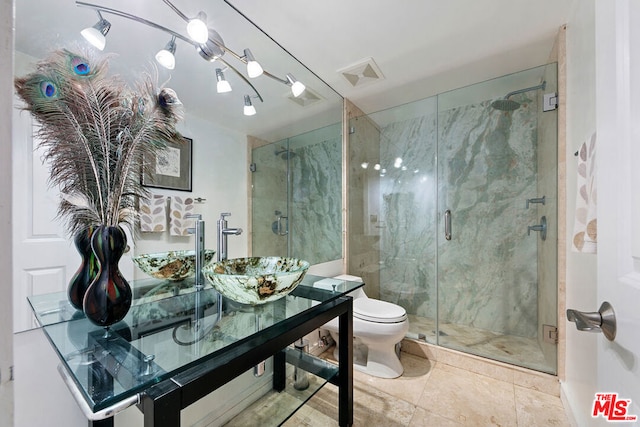 bathroom featuring vanity, an enclosed shower, and toilet