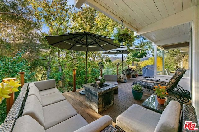 wooden deck with a grill and outdoor lounge area